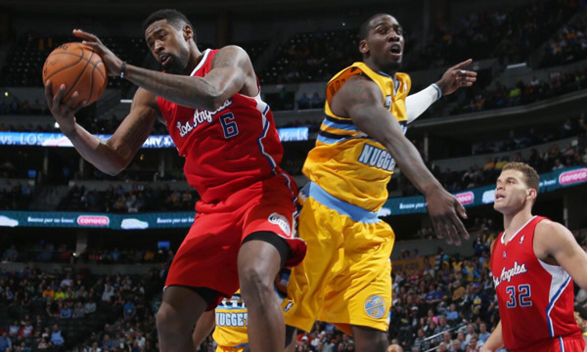 Clippers center DeAndre Jordan, left, grabs a rebound next to Denver Nuggets center J.J. Hickson during the Clippers' 116-115 road loss Feb. 3.