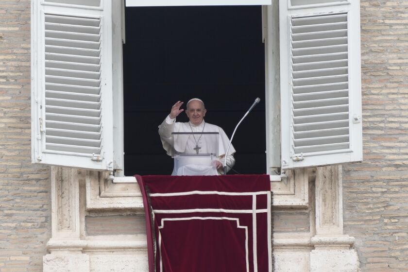 FILE - In this June 29, 2021, file photo, Pope Francis salutes from the window of his studio overlooking St. Peter's square at the Vatican, as he recites the Angelus prayer. The Vatican has detailed laws, rituals and roles to ensure the transfer of power when a pope dies or resigns. Even though Pope Francis is recovering from intestinal surgery in a Rome hospital, he is still very much in charge. (AP Photo/Gregorio Borgia, File)
