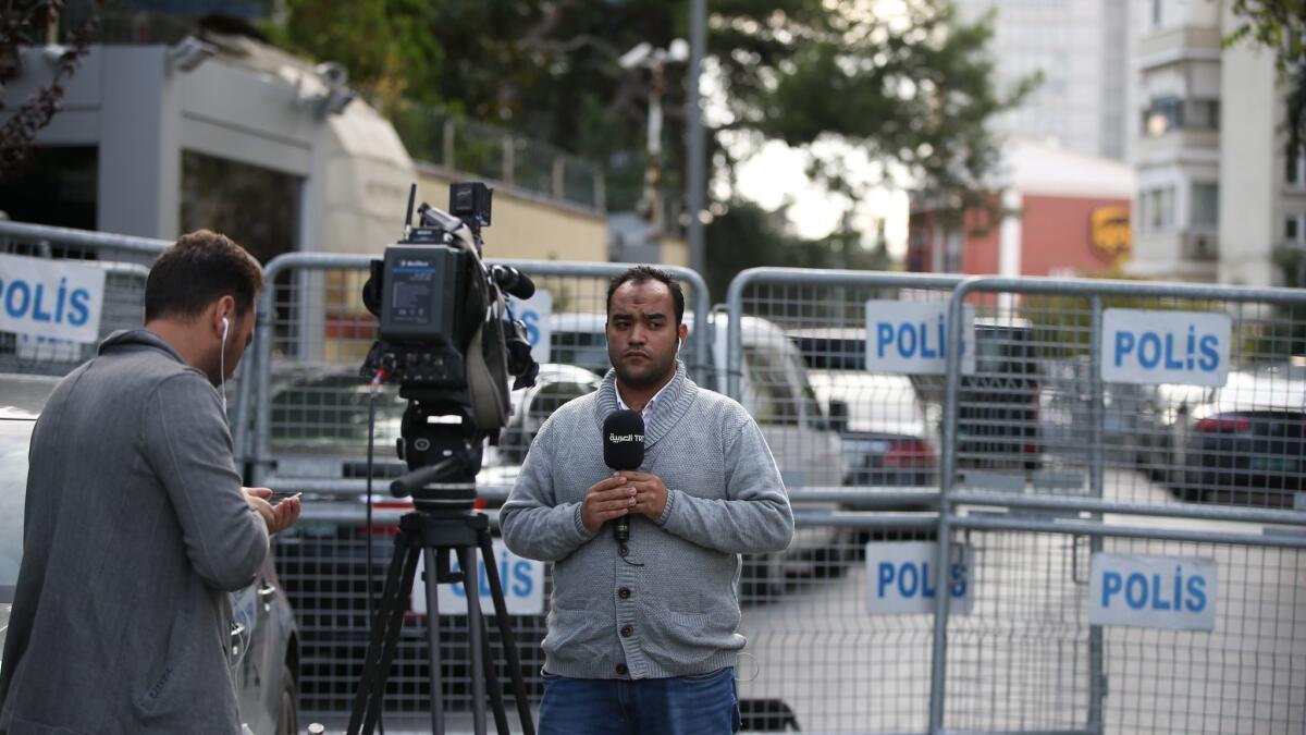 Journalists near the entrance to a blocked road leading to the Saudi Consulate in Istanbul, Turkey.