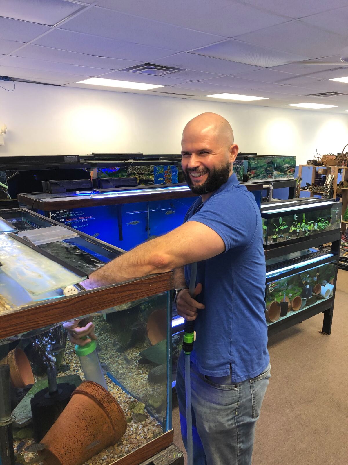 Dave Gorrasi, 41, adjusts a fish tank in his aquatics store.