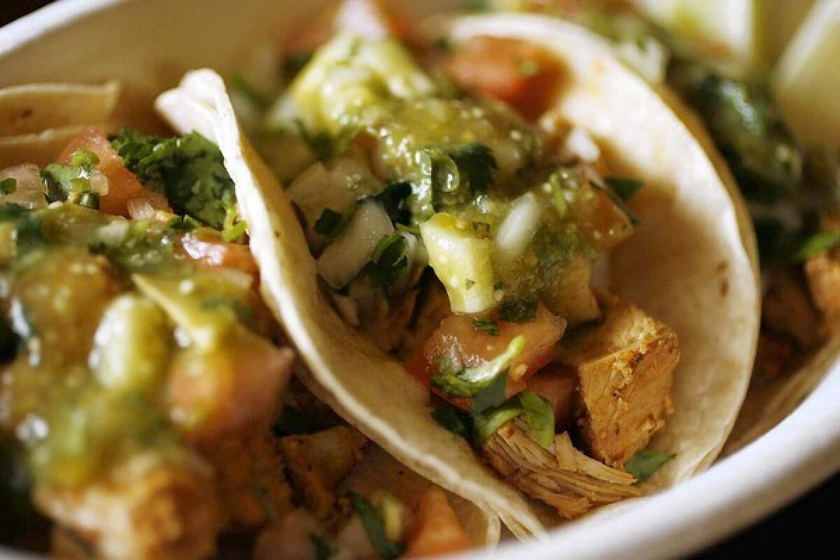 Popular dish taco trio chicken tacos are packed with pico de gallo and salsa verde at Ara's Tacos in Glendale.
