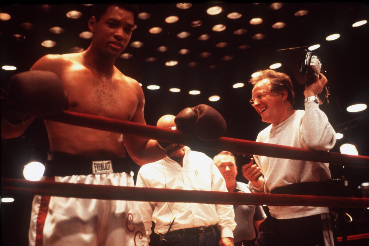 An actor gets notes from a director in a boxing ring.