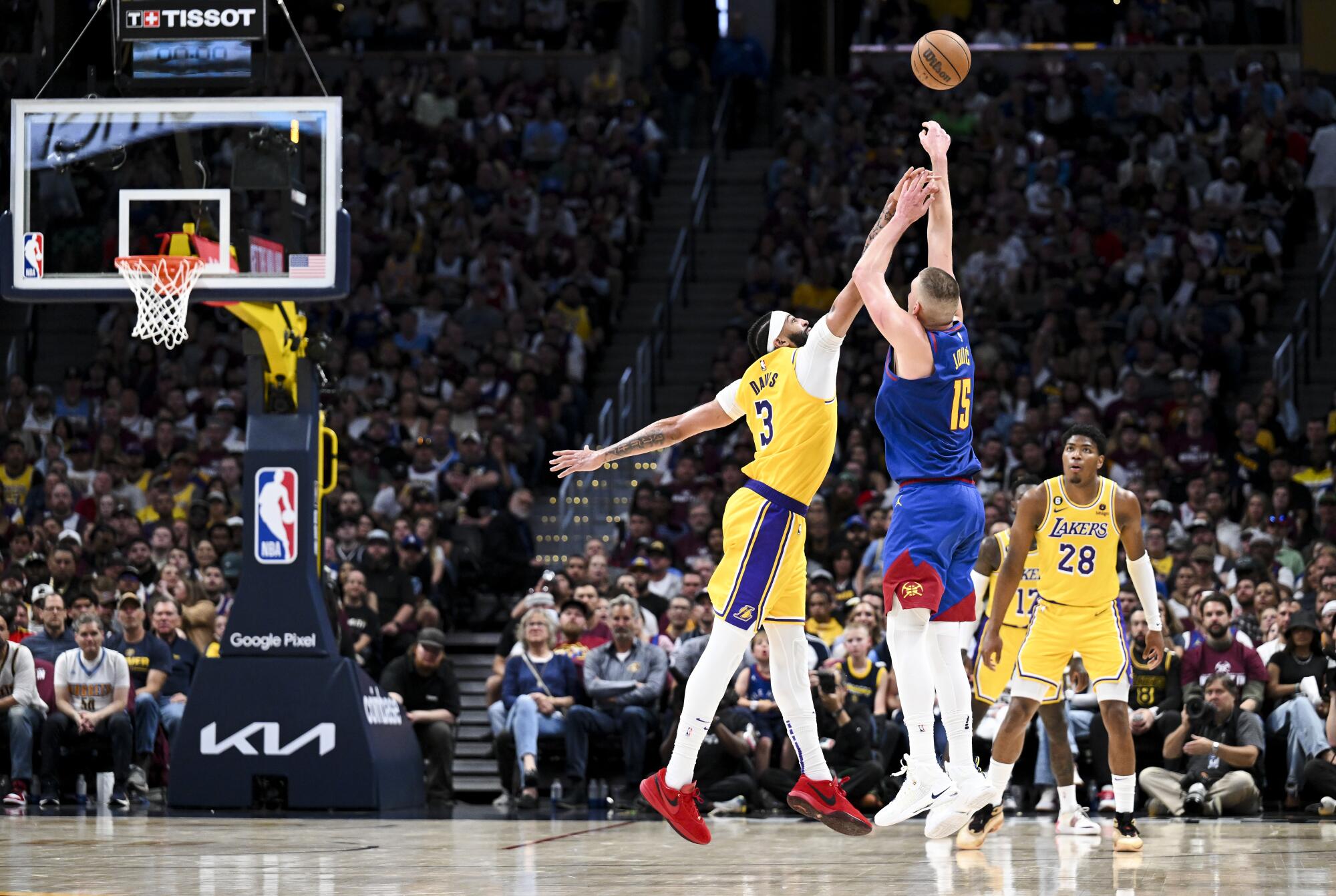 Nuggets center Nikola Jokic, right, shoots a three-point basket over Lakers forward Anthony Davis during the second half.