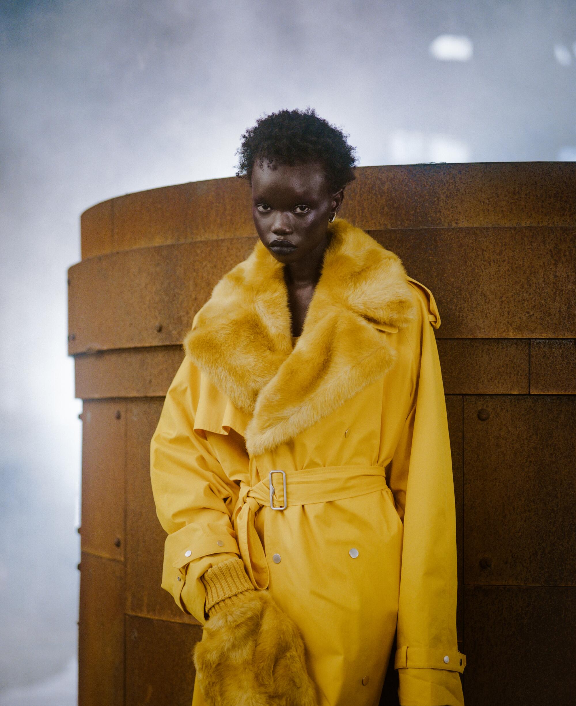 Model in a yellow trench coat