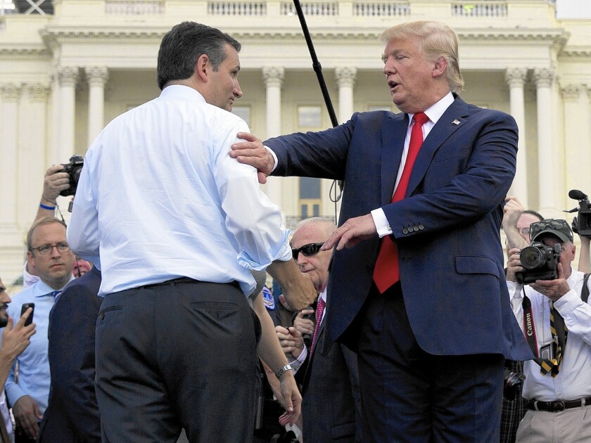 Republican presidential candidates Ted Cruz, left, and Donald Trump meet onstage during a rally outside the Capitol against the Iran nuclear agreement.