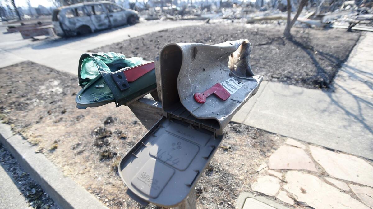 Melted mailboxes near burned properties in Santa Rosa on Thursday. Travelers whose homes have been destroyed may be able to recoup costs from their trip insurance.
