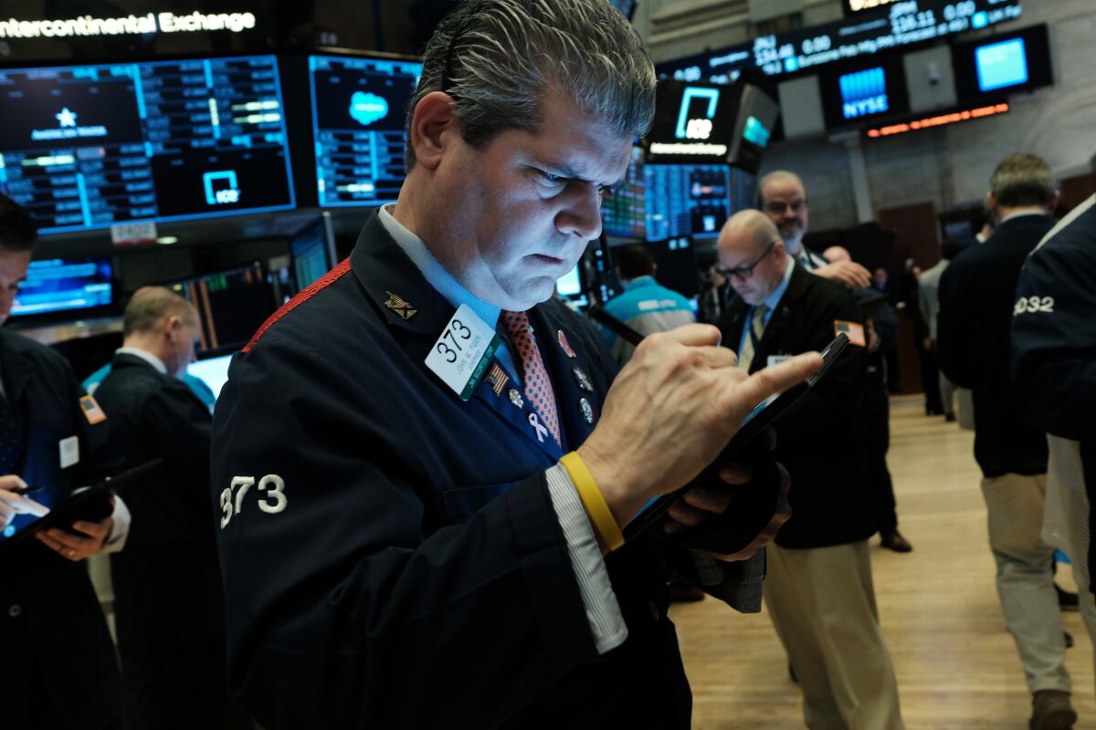 A man looks at a handheld electronic device