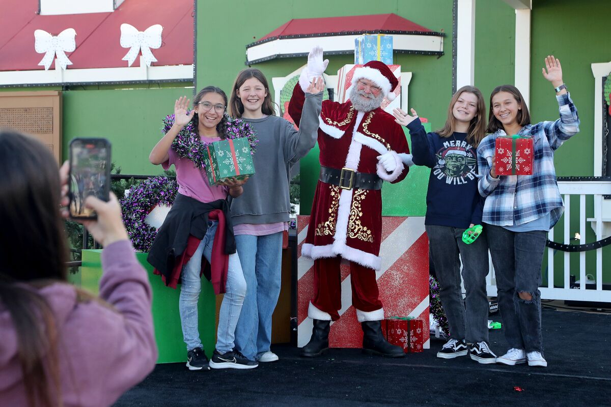 Orange County youths pose for photos with Santa Claus Wednesday during a sneak preview of Winter Fest O.C.