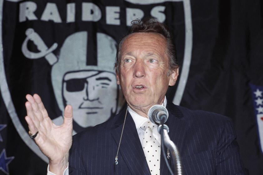 Los Angeles’ owner Al Davis gestures at a press conference at Memorial Coliseum in Los Angeles on Tuesday, Sept. 11, 1990 after announcing he signed a 20-year deal with the city to keep the Raiders in Los Angeles. The agreement, which ends talks with other cities hoping to attract the AFC team, includes renovations to the Coliseum with funds totaling $145 million. (AP Photo/Nick Ut)
