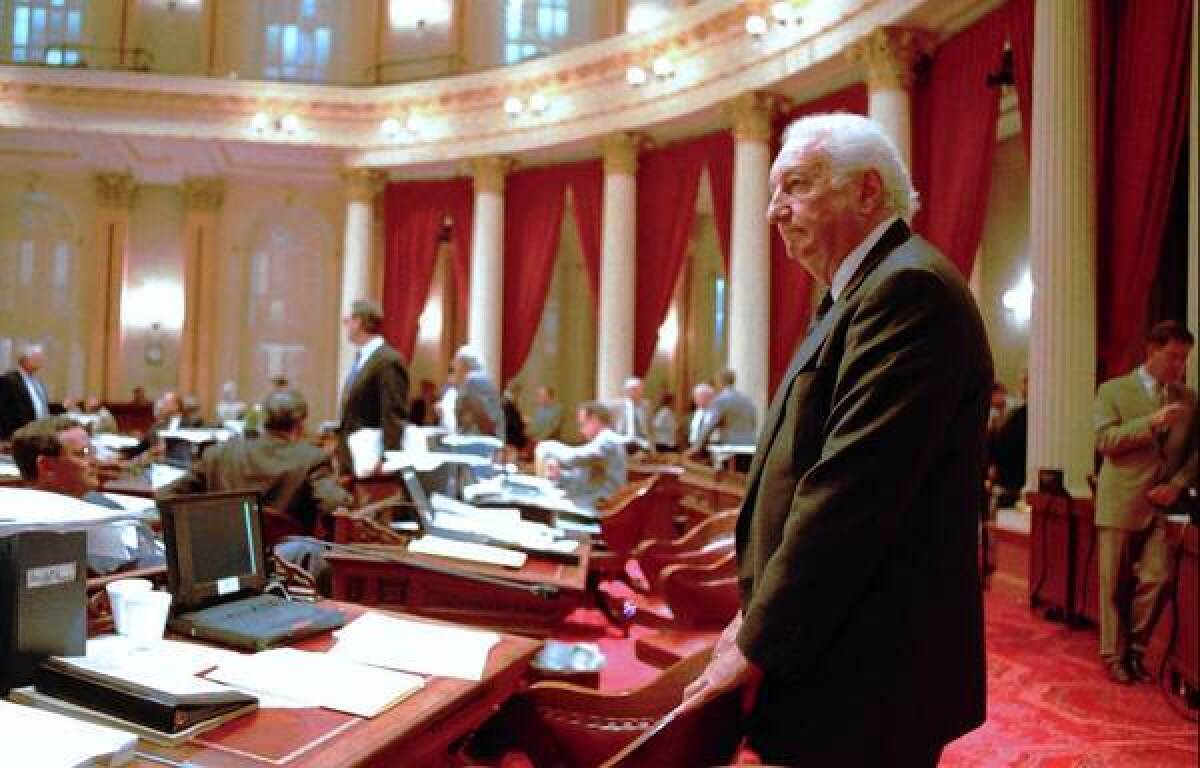 Nicholas Petris on the floor of the state Senate in 1996. In the Legislature he wrote laws barring smoking on planes, trains and buses in the state and introduced a bill calling for the elimination of the internal combustion engine.
