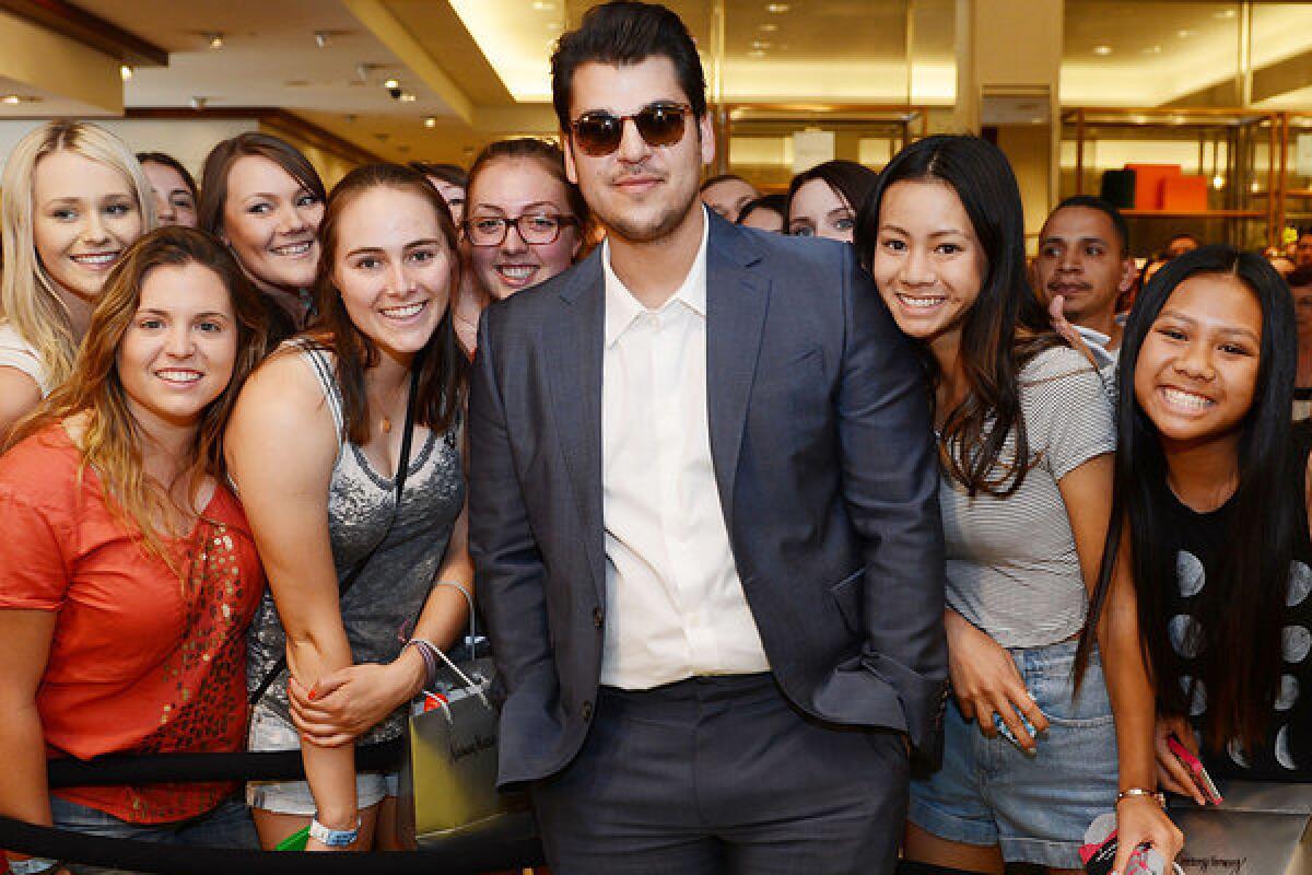 Rob Kardashian poses with fans during his new Arthur George by Rob Kardashian sock collection unveiling at Neiman Marcus last month in Las Vegas.