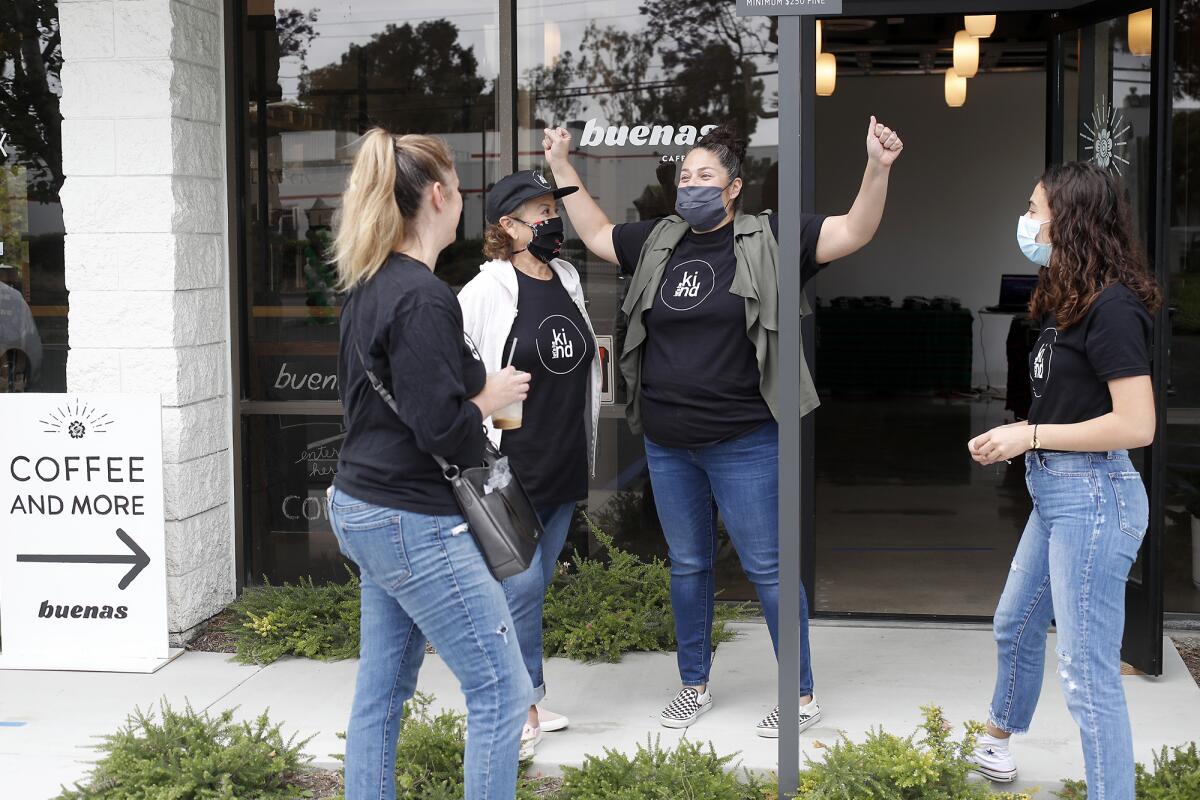 Rebekah Robeck, 16, far right, her mother, Cristina, center, and grandmother, Rose Lopez, talk to parent Sarah Yagerlener, far left, at Buenas Coffee on Friday.