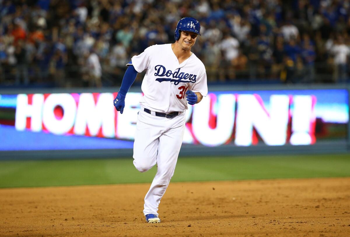 Dodgers rookie outfielder Joc Pederson smiles as he rounds the bases after hitting a solo home run against the Giants.