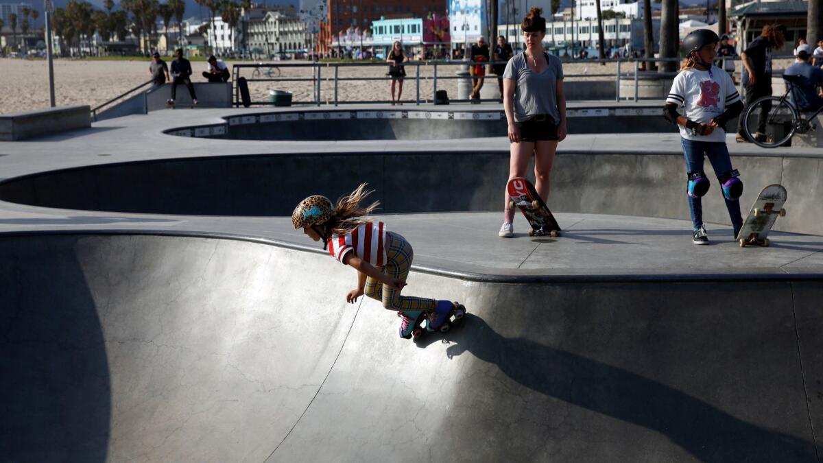 Liberty Lilley roller-skates down one of the bowls at Venice Beach Skate Park.