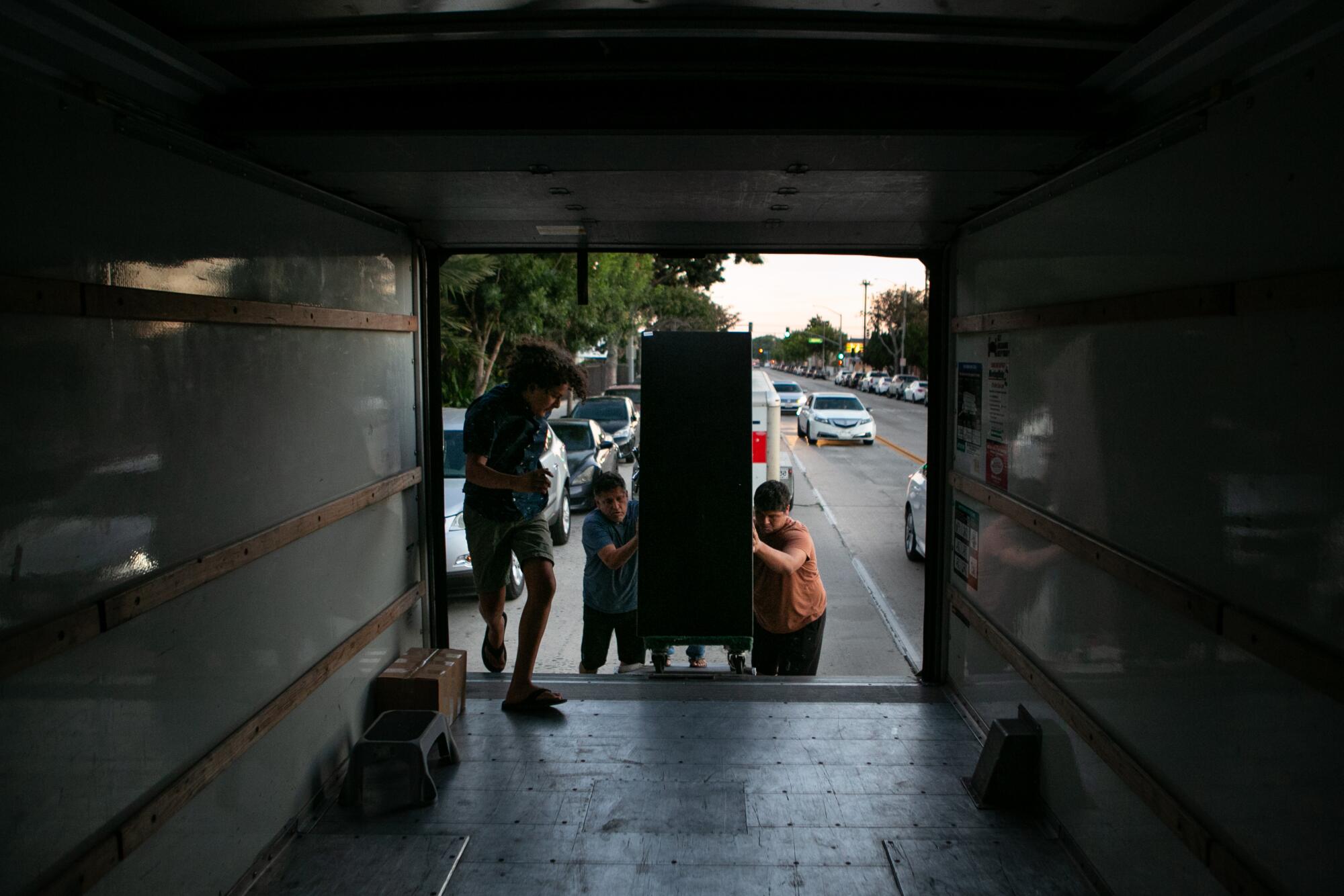 Teenagers load a U-Haul truck