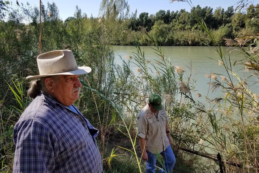 DELORES TEXAS DECEMBER 11, 2019 -- Mauricio Vidaurri, 61, (right) and brother Jose Vidaurri, 67, (left) both of Laredo, Texas, worry the border wall could block their riverfront ranch's access to the Rio Grande river, which they use for irrigation. (Molly Hennessy-Fiske / Los Angeles Times)