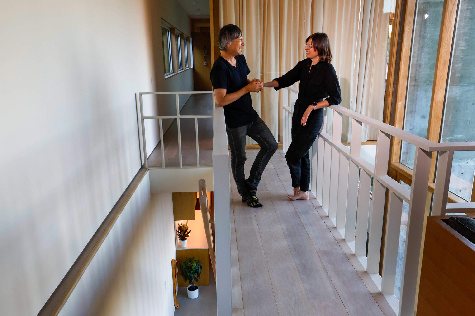 Simon Storey and Jen Holmes on the second floor of their home.