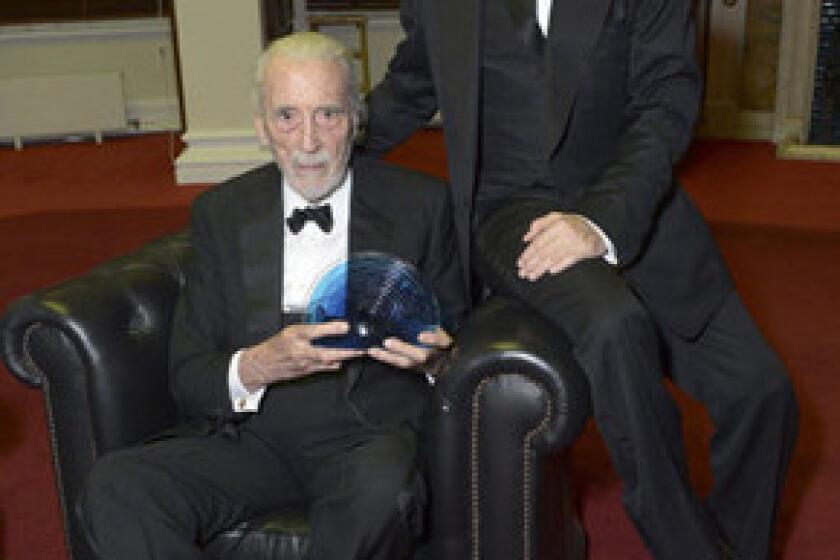 British actor Sir Christopher Lee, left, received the BFI Fellowship award from a blond Johnny Depp at he 57th BFI London Film Festival Awards.