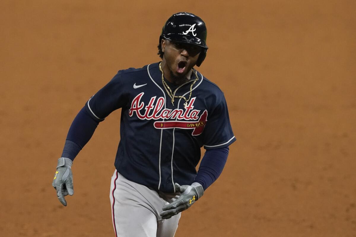 Atlanta's Ozzie Albies celebrates after hitting a two-run home run against the Dodgers.
