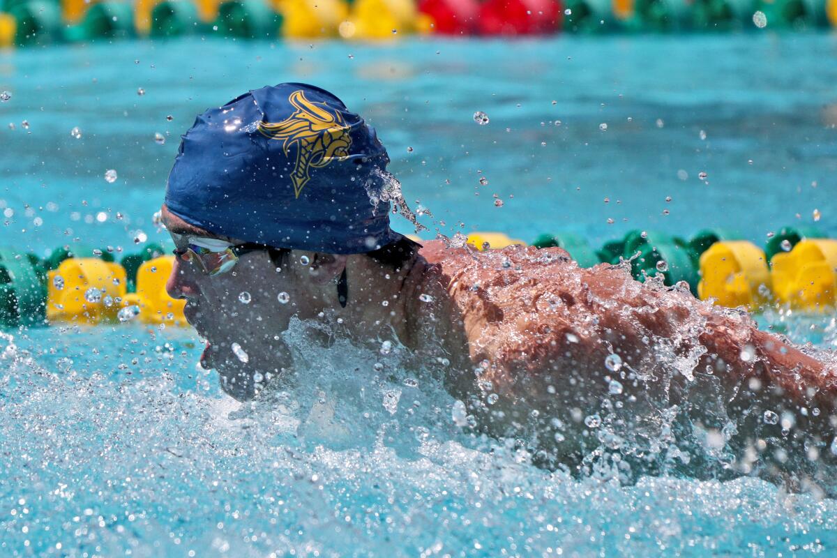 Marina's Stuart Holton wins the 100-yard butterfly in the Wave League finals at Golden West College in Huntington Beach on April 25, 2019.