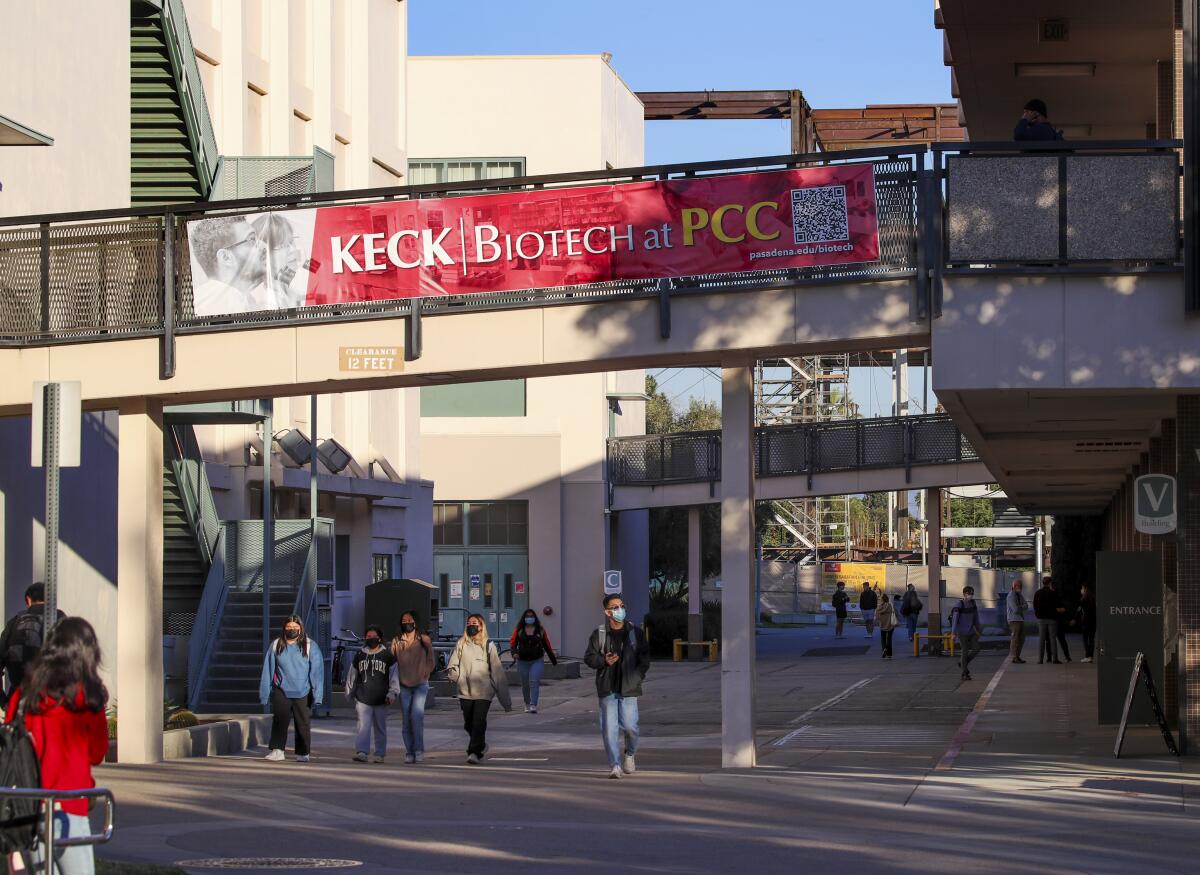 Students walk across the Pasadena City College campus under a Keck Biotech banner