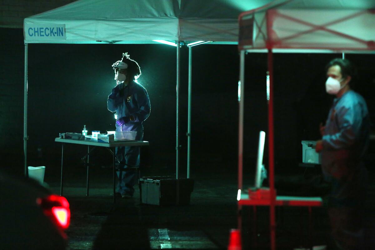 Actors rehearse "5711 Avalon," set up in a parking lot to depict a drive-through COVID-19 testing site.