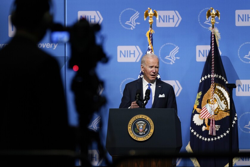 President Joe Biden speaks about the COVID-19 variant named omicron during a visit to the National Institutes of Health, Thursday, Dec. 2, 2021, in Bethesda, Md. Biden looked out over an audience of government scientists and framed his latest plan for fighting COVID-19 as an opportunity to at last put an end to divisiveness over the virus, calling the politicization of the issue a “sad, sad commentary.” And then he tacked on a political dig. Some people “on the other team,” he said Thursday, were threatening to hold up government spending and endangering the nation’s credit out of pique over vaccination requirements. “Go figure,” he added. (AP Photo/Evan Vucci)