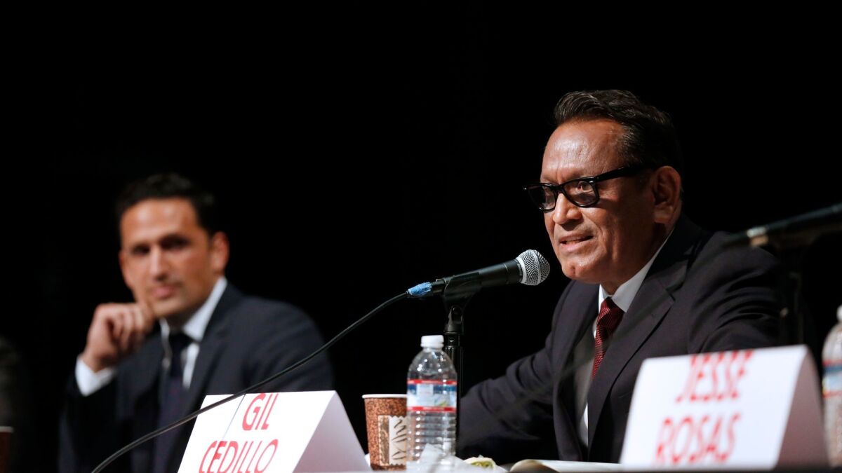 Challenger Joe Bray-Ali, left, and Councilman Gil Cedillo at a City Council District 1 candidates forum at Sotomayor Learning Academies complex on Feb. 16.