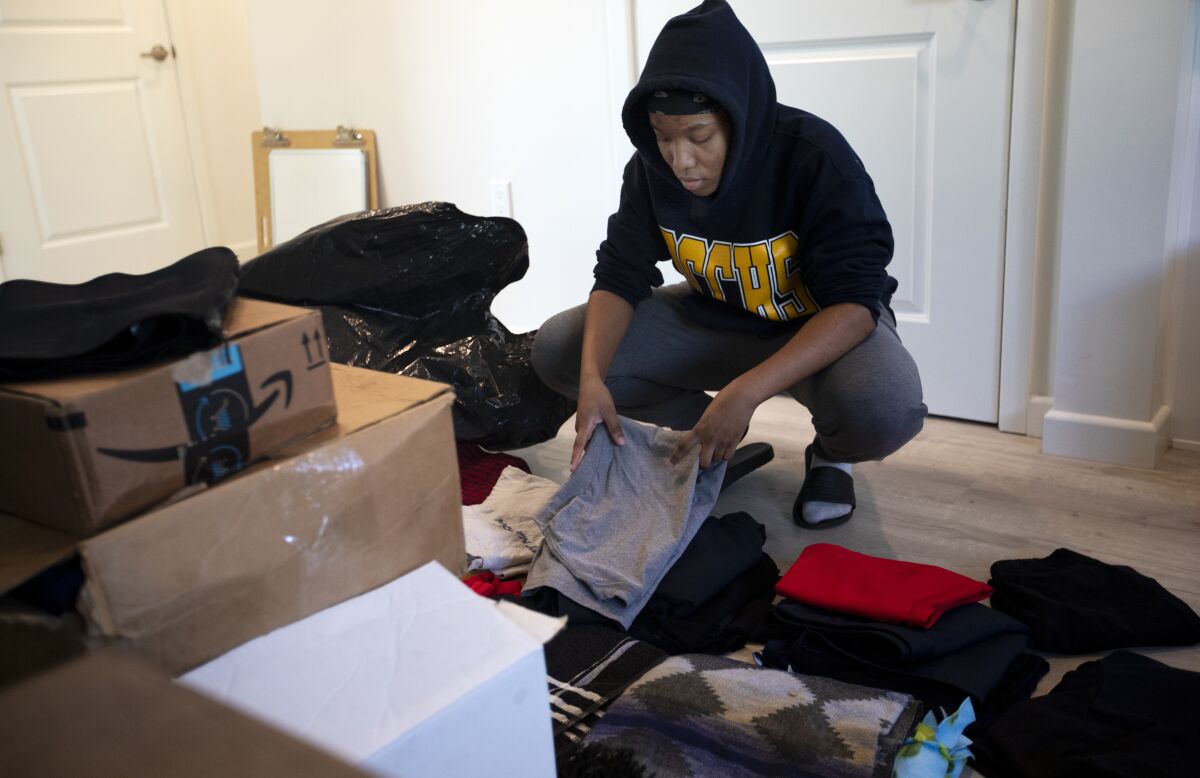 Khalila Sanders, 16, unpacks inside her new home in North Hills.