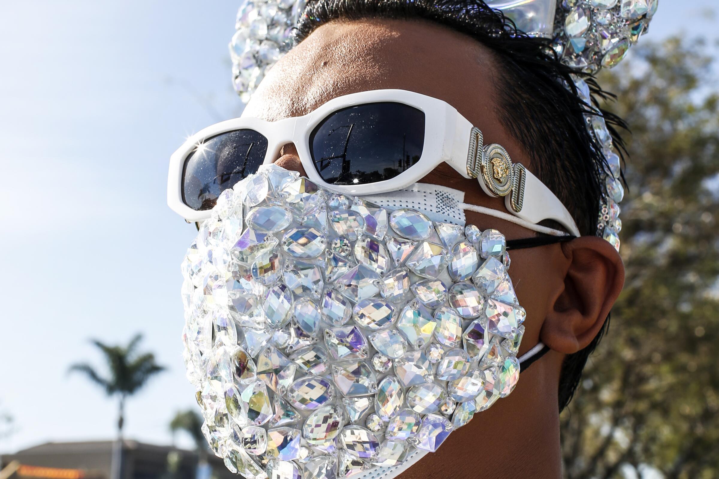 Jose Guerrero wears a bejeweled face mask before entering Disneyland on Friday