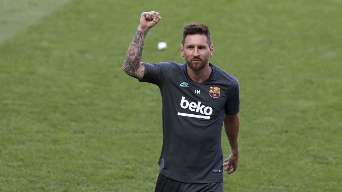Barcelona's Lionel Messi gestures during a training session at the Luz stadium in Lisbon, Thursday Aug. 13, 2020. Barcelona will play Bayern Munich in a Champions League quarterfinals soccer match on Friday. (Rafael Marchante/Pool via AP)