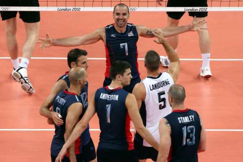 Members of the men's U.S. Olympic volleyball team celebrate their victory over Germany.