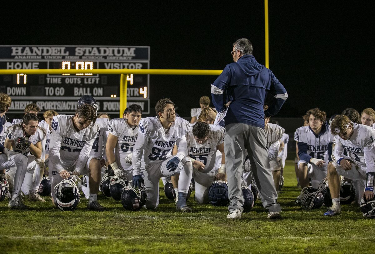 Newport Harbor head coach Peter Lofthouse addresses his team following a loss against Cypress on Friday.