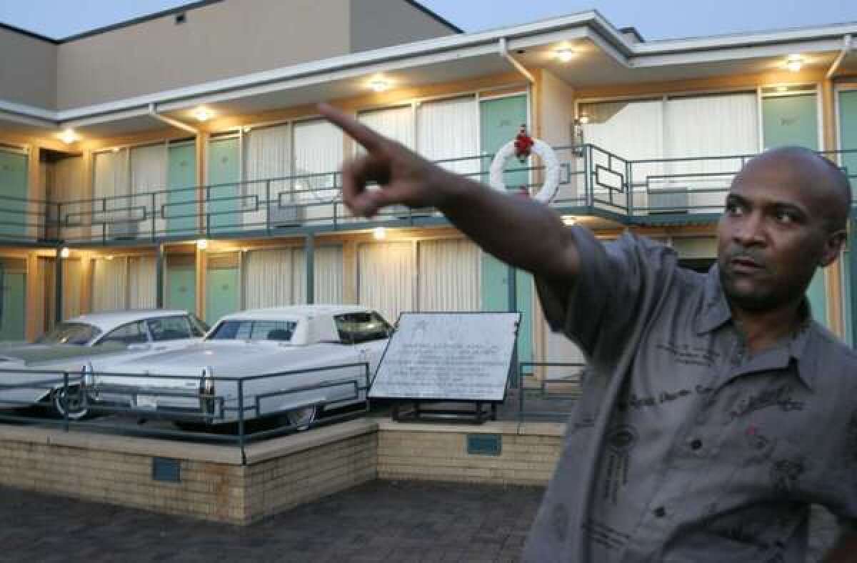 During a visit to the National Civil Rights Museum, Memphis resident David Tate tells visiting family, in July 2007, the direction from which a gunman fired a shot that killed Martin Luther King Jr.