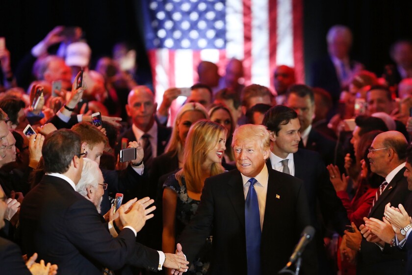 Donald Trump greets supporters at Trump Tower in Manhattan on Tuesday night after his victory in the Indiana primary drove rival Ted Cruz from the race for the Republican presidential nomination.
