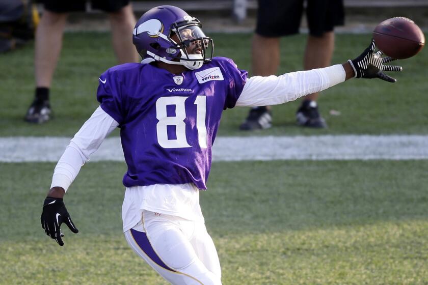 Vikings receiver Jerome Simpson reaches for a pass during summer camp.