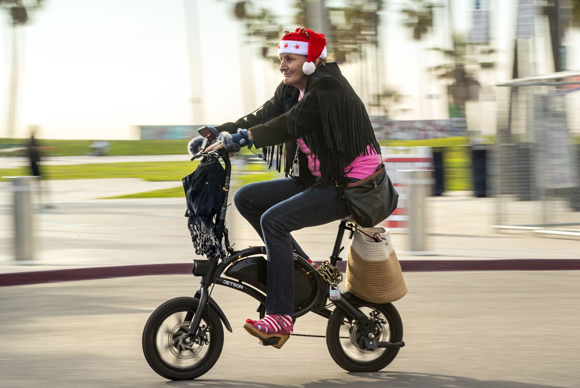 A woman called Funky T gets into the holiday spirit while riding her bike in Venice Beach.