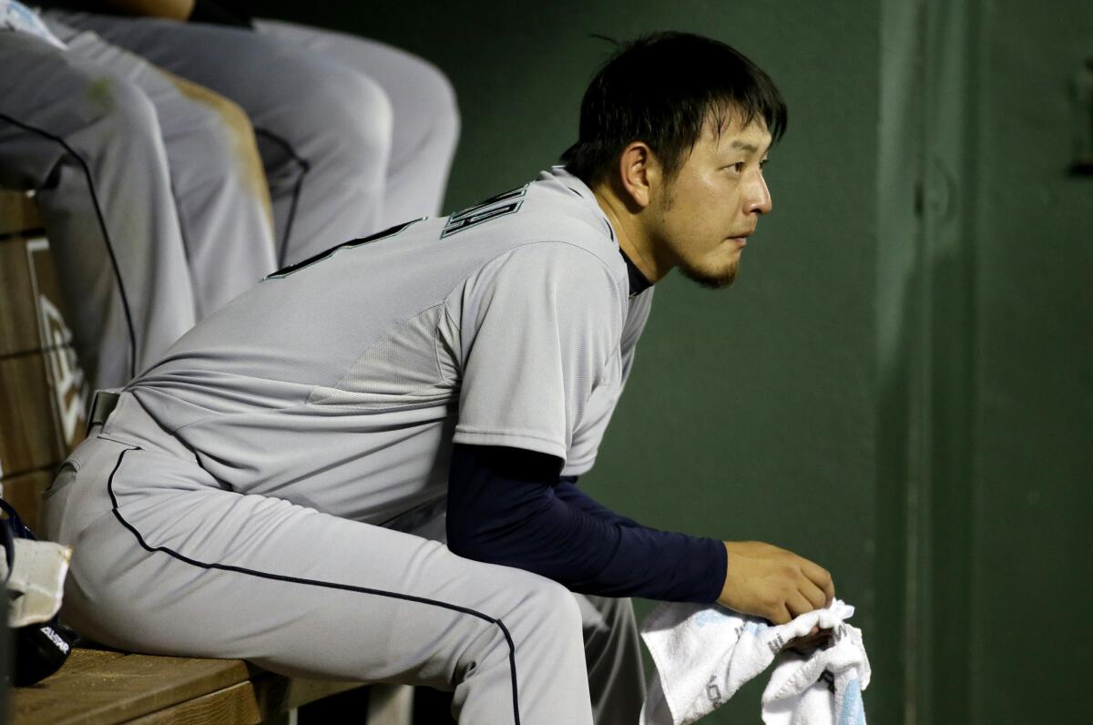 Seattle pitcher Hisashi Iwakuma sits in the dugout during a game against Texas on Aug. 18.