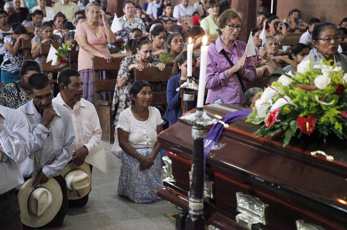 Mourners pray at the funeral for Lesbia Janeth Urquia, an environmentalist and indigenous rights activist, in Marcala, Honduras, on July 8, 2016.