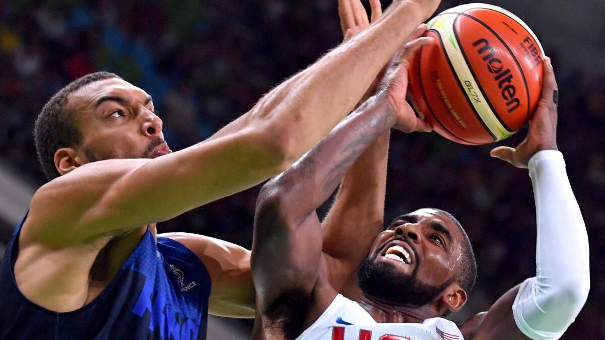 U.S. guard Kyrie Irving tries to score on a layup against France center Rudy Golbert during their Group A game Sunday.