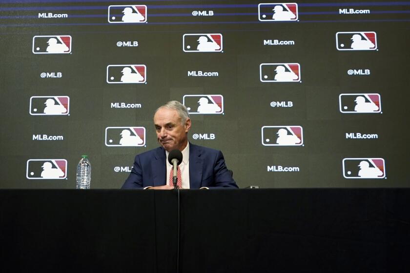Major League Baseball commissioner Rob Manfred pauses during a news conference in Arlington, Texas, Thursday, Dec. 2, 2021. Owners locked out players at 12:01 a.m. Thursday following the expiration of the sport's five-year collective bargaining agreement. (AP Photo/LM Otero)