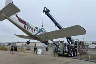 A plane that made an emergency landing Thursday on state Route 76 near Canyon Drive in Oceanside is hauled into an airport to be housed and investigated by Federal Aviation Administration investigators. (Oceanside Police Department)