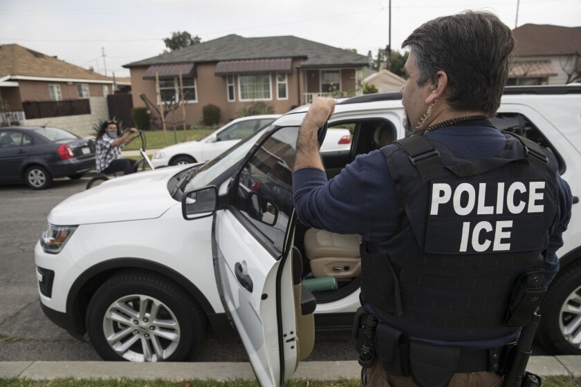 An Immigration and Customs Enforcement fugitive operations team member outside the Montebello home of a 47-year-old Mexican national in 2017.