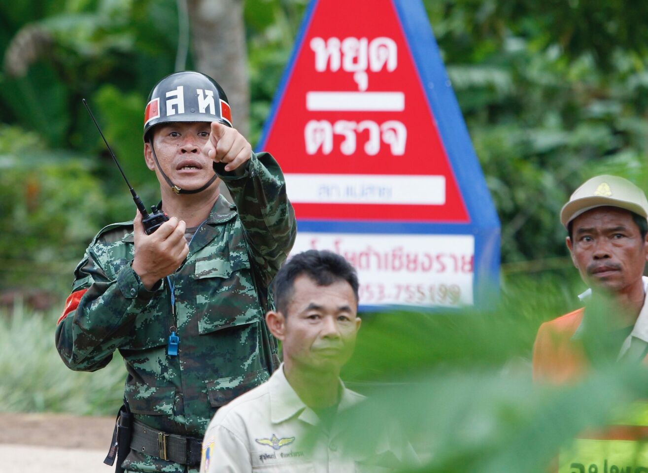 A Thai soldier helps direct the evacuation operation after all 12 boys of a soccer team and their coach were rescued from the cave complex on July 10.