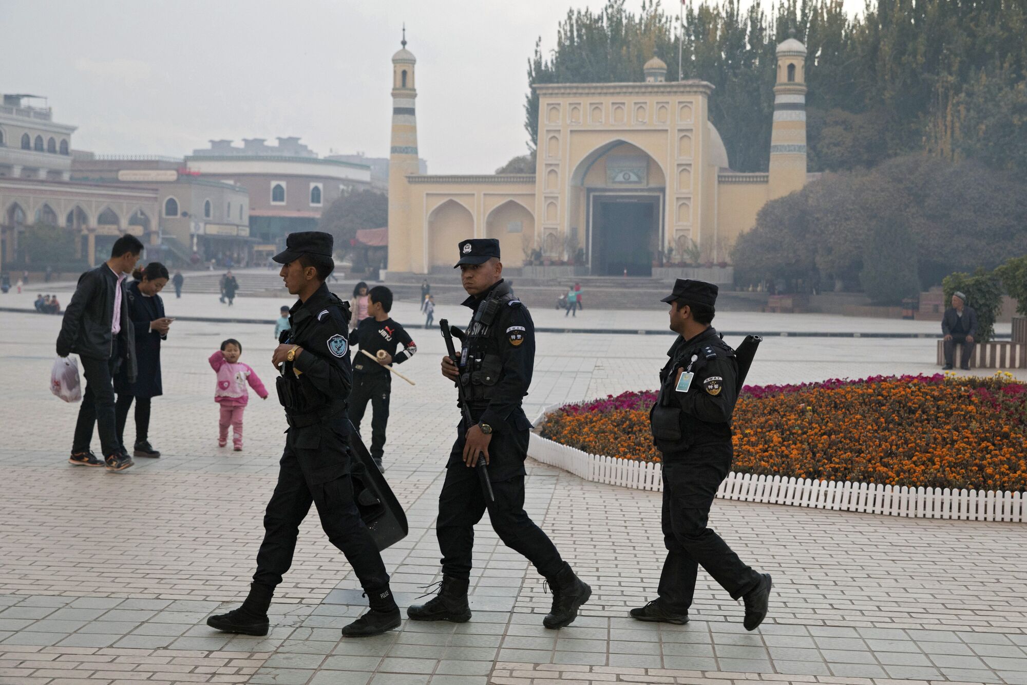 Uighur security personnel patrol near the Id Kah Mosque in Kashgar, Xinjiang.