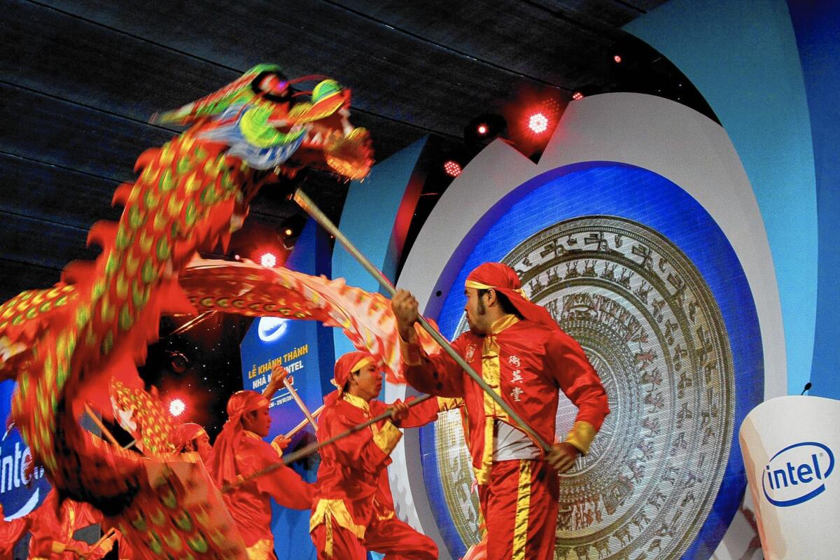 Intel is adding more complex products made at its semiconductor factory in Ho Chi Minh City, Vietnam. Above, a dragon dance is performed at the opening ceremony of the facility in 2010.