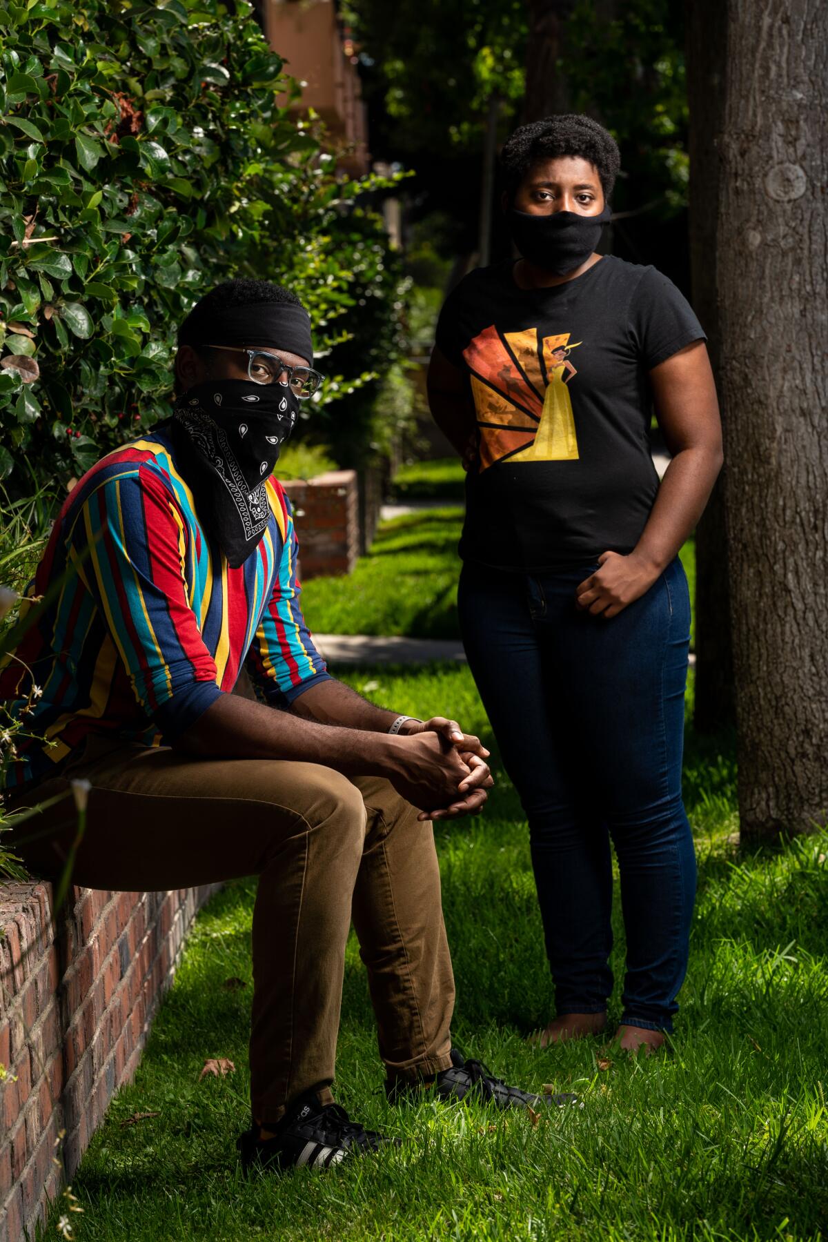 Waymond Singleton and Breana Williams, founders of Black N' Animated and hosts of its podcast, pose in masks.