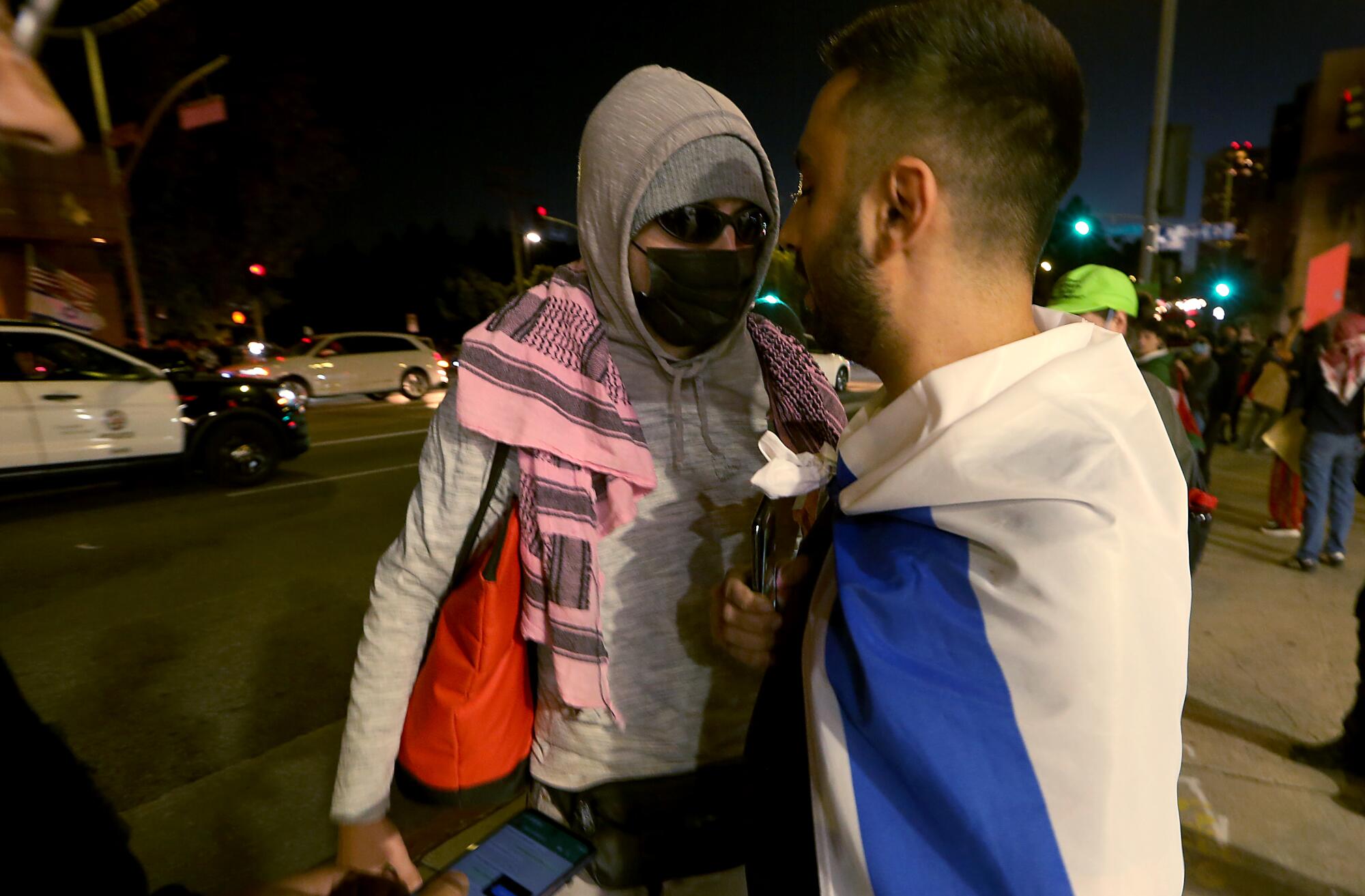 A supporter of Paletsine, left, faces poff against a supporter of Israel outside of The Museum of Tolerance in Los Angeles.