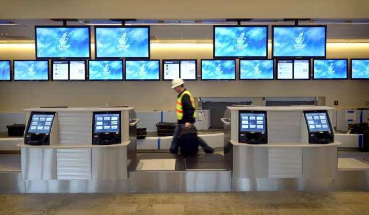 A worker walks through a terminal at John Wayne Airport.