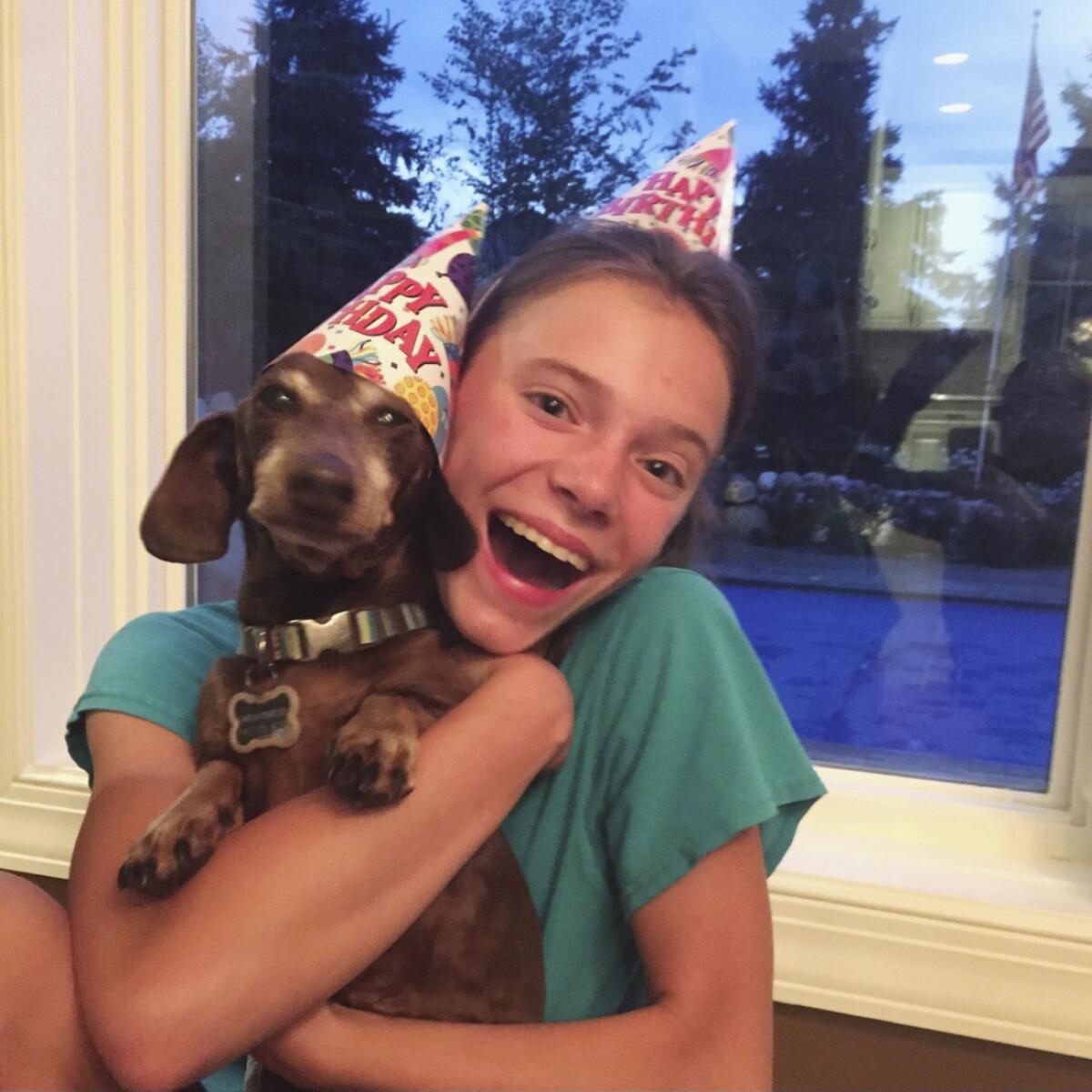 Peyton Crest with her dog at home in Minnetonka, Minn.